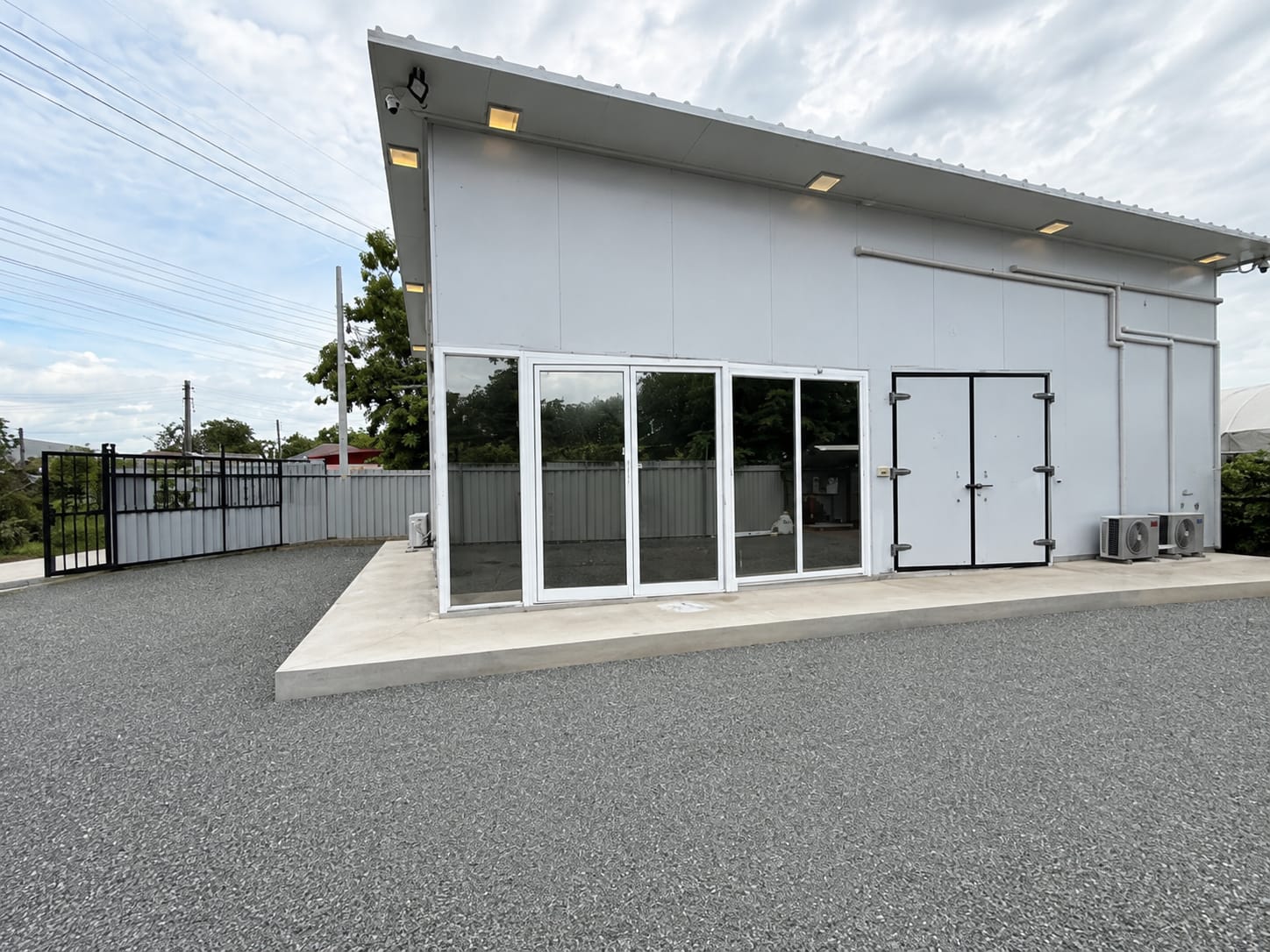 Exterior of a modular building with glass doors (placeholder -- to be replaced with a real facility photo)